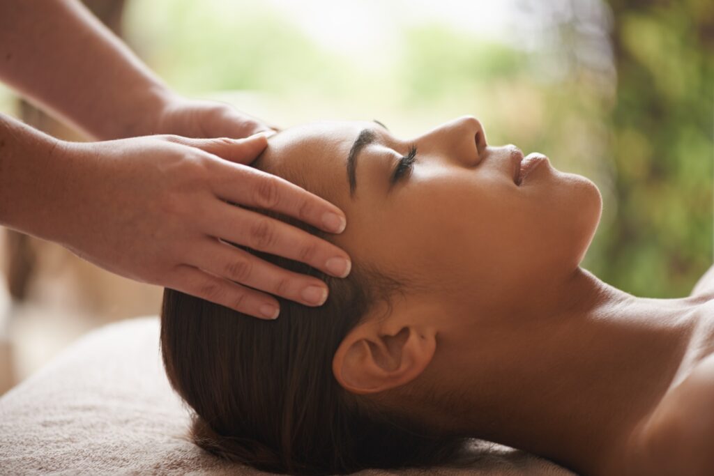 Shot of a beautiful young woman getting a head massage at a spa